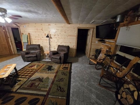Living room with lake view. 
 Smart TV with DirecTV. 
 Seats up to seven people comfortably.  Two rocker recliners.  Wood burning fireplace including wood for your stay.  Ceiling fan and blind/curtains for your privacy.