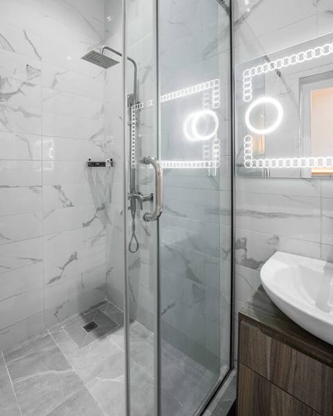 Step into comfort in our beautifully tiled bathroom, designed for your rejuvenation.