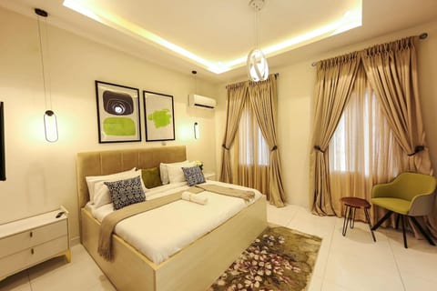 A spacious bedroom with elegant decor and a cozy bed, perfect for relaxing and recharging.