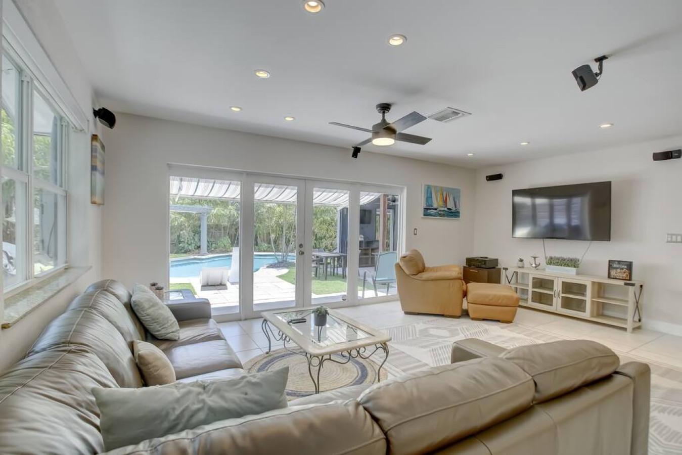 “Warning: This living room may lead to an unhealthy obsession with fuzzy blankets and throw pillows.”