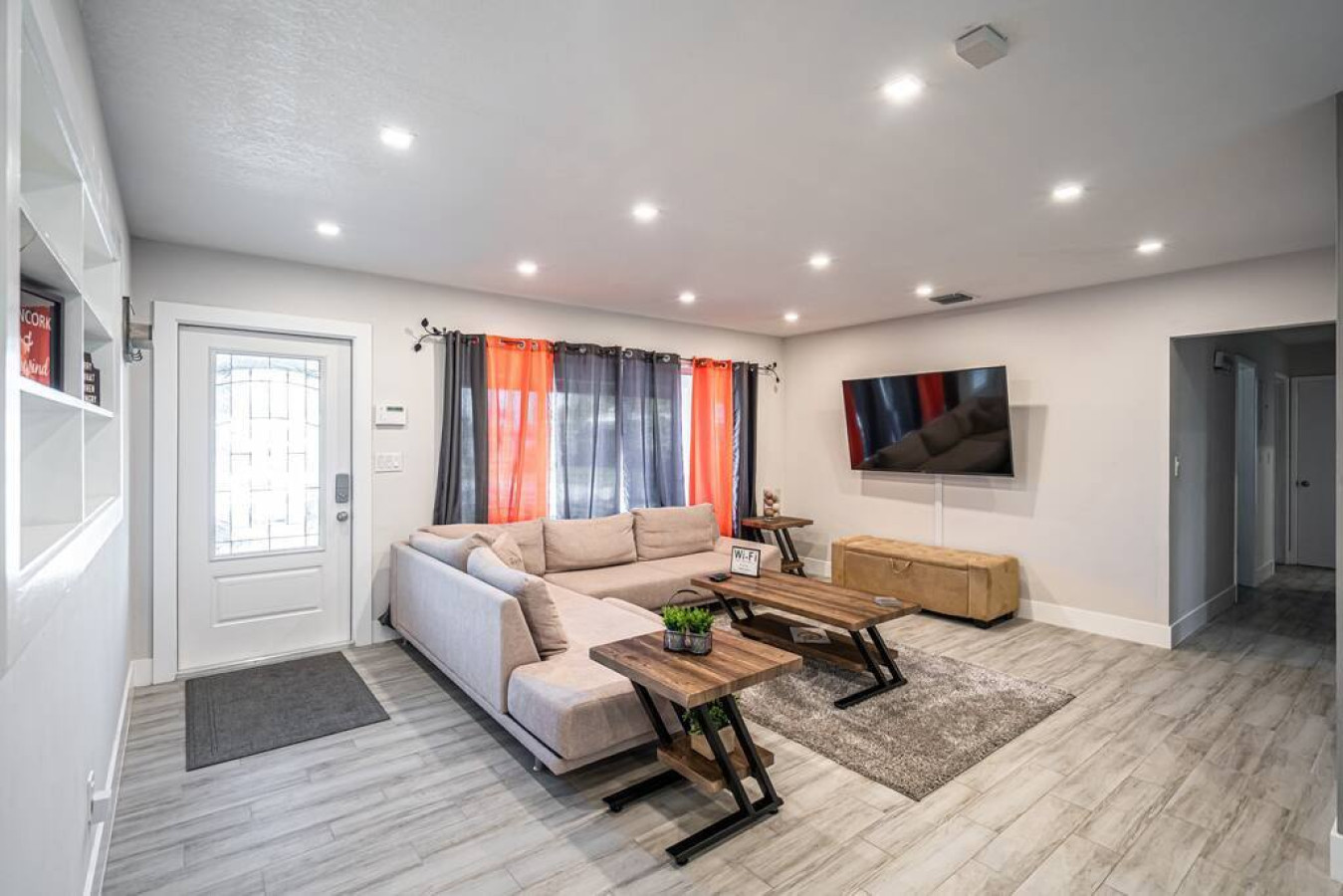 "Neutral tones, plush textures, and pops of greenery - this living room is an invitation to relax, unwind, and connect with loved ones."