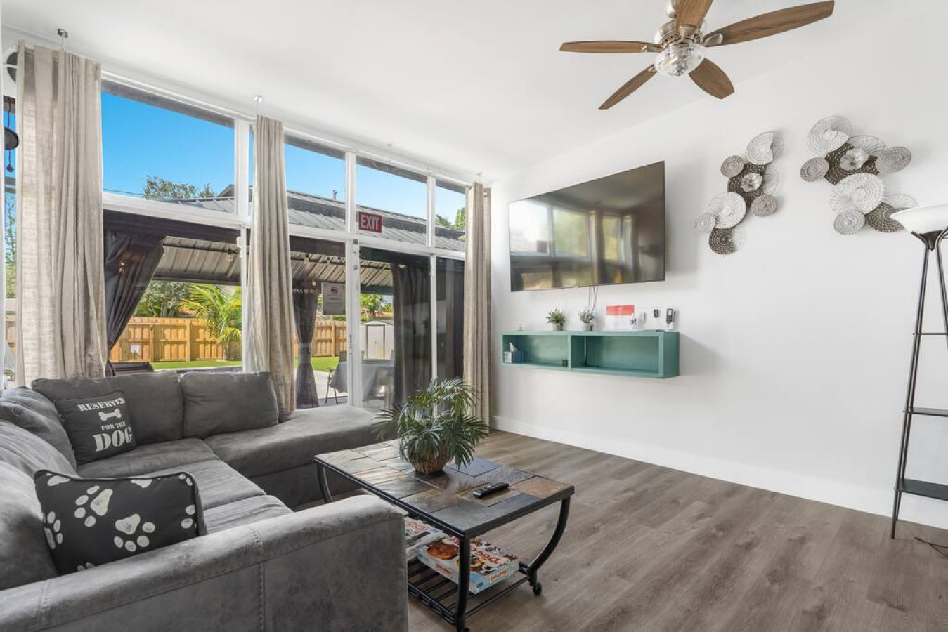 "Sunlight streams through the window, casting warm shadows on a couch that begs you to curl up with a good book and a cup of tea."