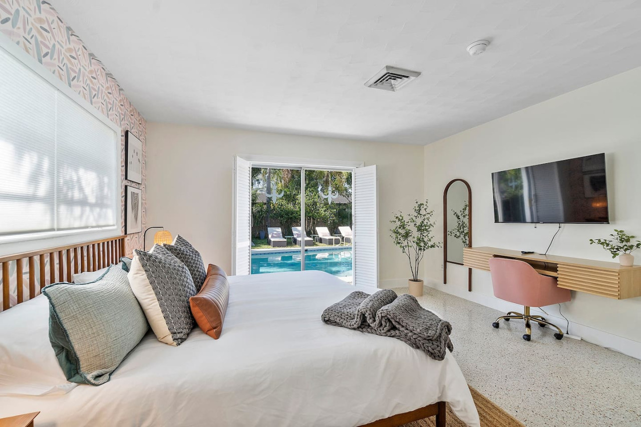 A luxurious bedroom featuring a king-sized bed and a private ensuite bathroom