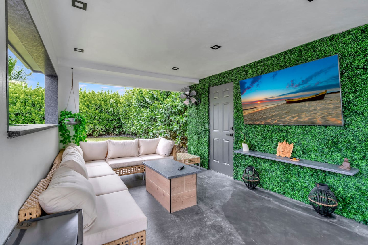Enjoy outdoor living on the covered patio, complete with seating and a TV