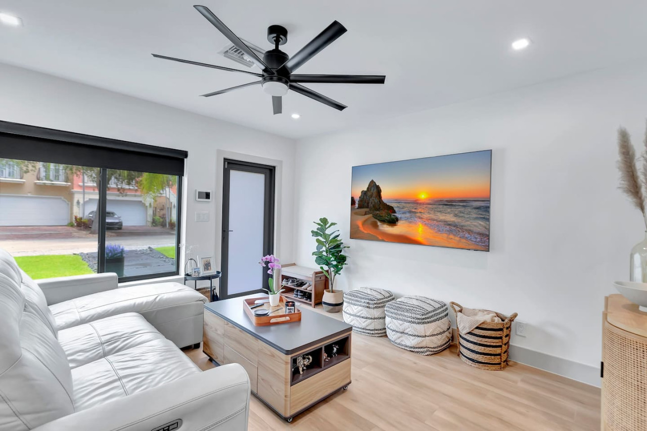 Modern living room featuring a 75-inch TV and comfortable seating.