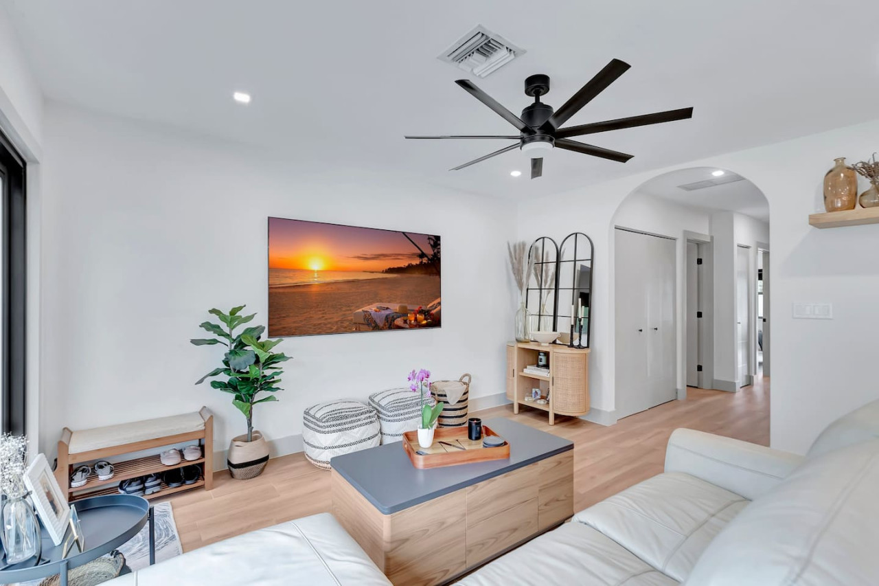 Modern living room featuring a 75-inch TV and comfortable seating.