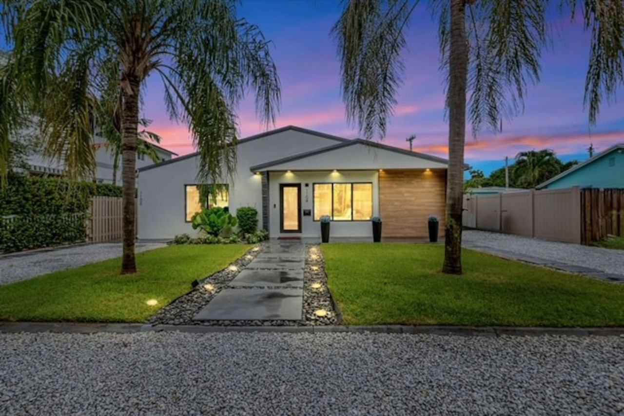 Beautifully lit exterior showcasing the home’s charm at night.