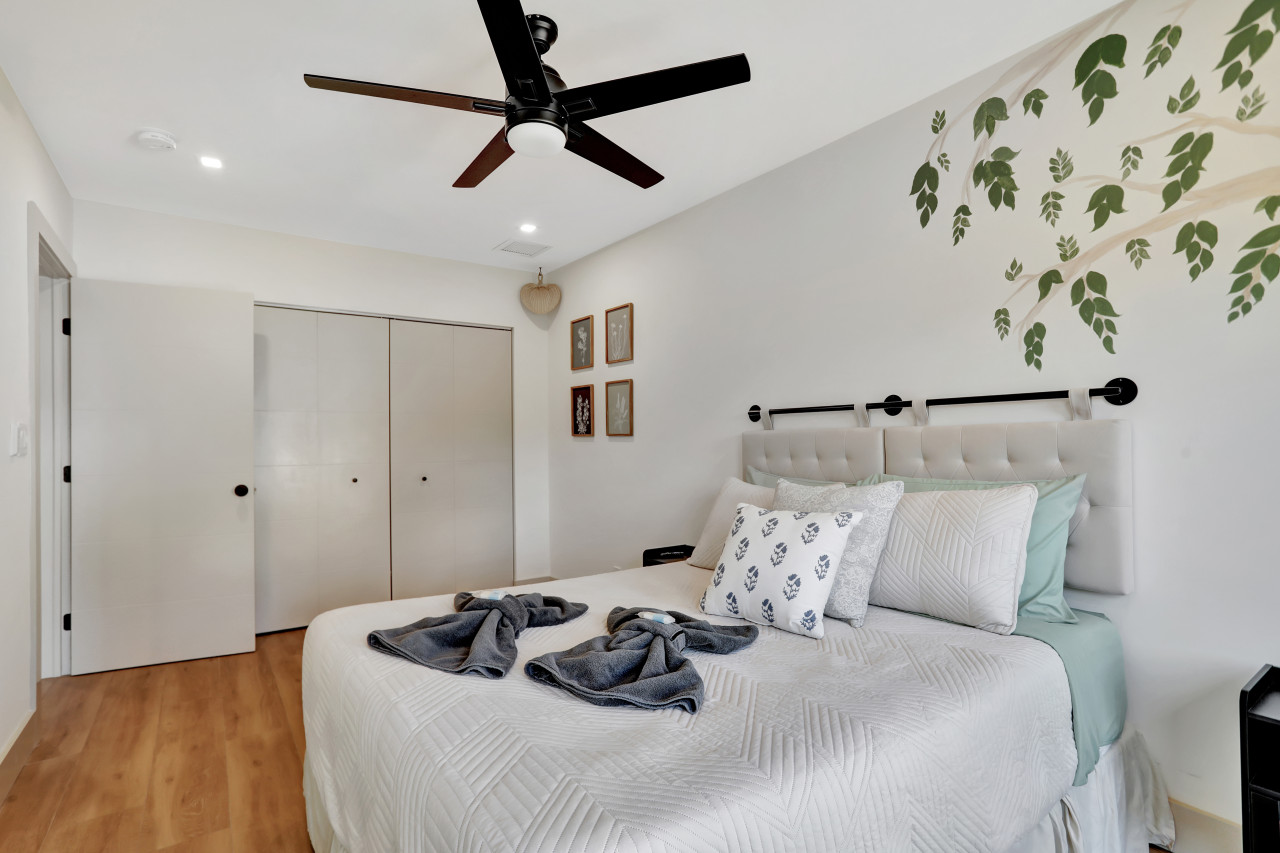 Unit 2, Bedroom 2: Enjoy the comfort of a queen bed with convenient backyard access.