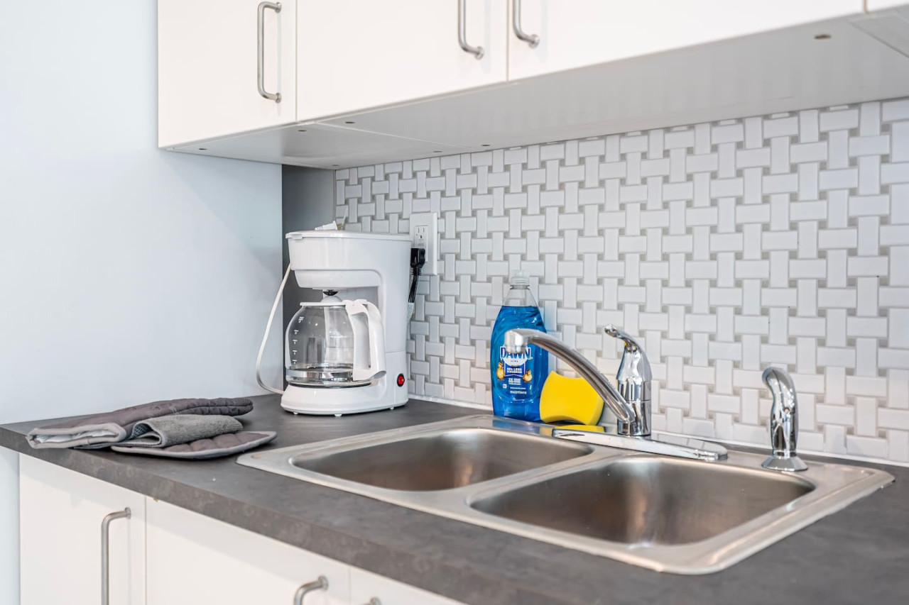 Gleaming chrome and crisp countertops - this kitchen sink is a picture of modern efficiency.