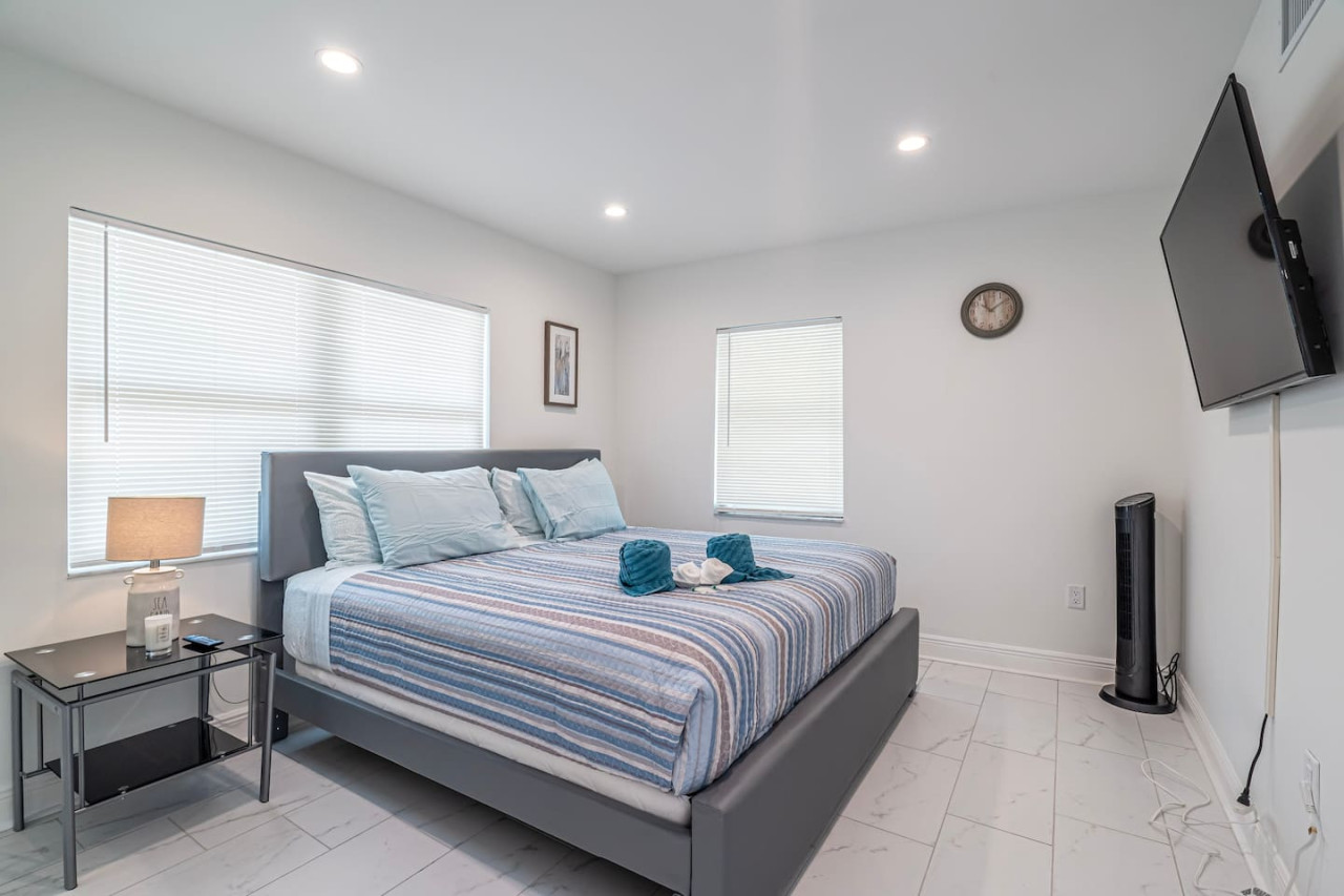 This bedroom is a sanctuary of comfort, where crisp linens and fluffy pillows promise a restful night's sleep. The gentle hum of the ceiling fan creates a soothing lullaby.
