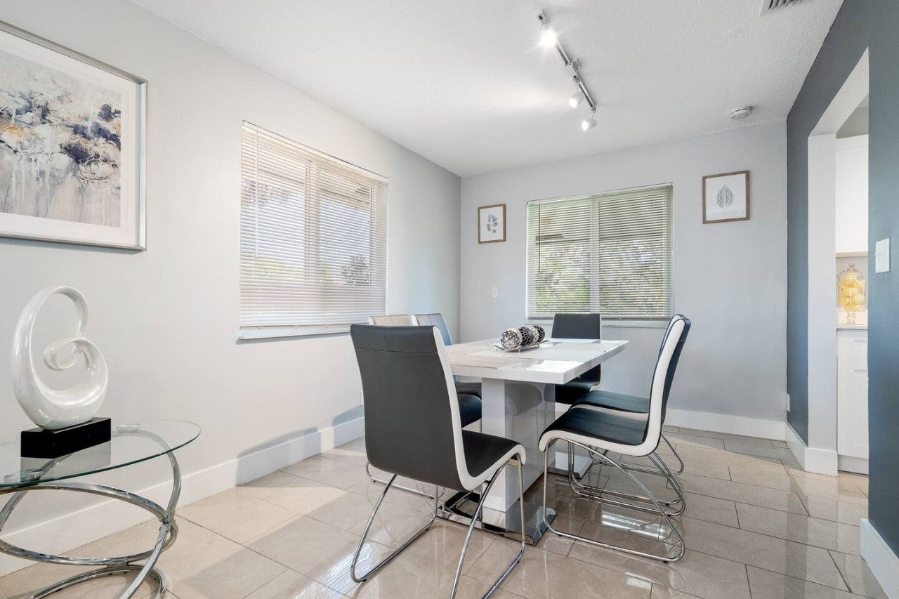 A dining room with a minimalist table and chairs. The perfect place to enjoy a simple and elegant meal.