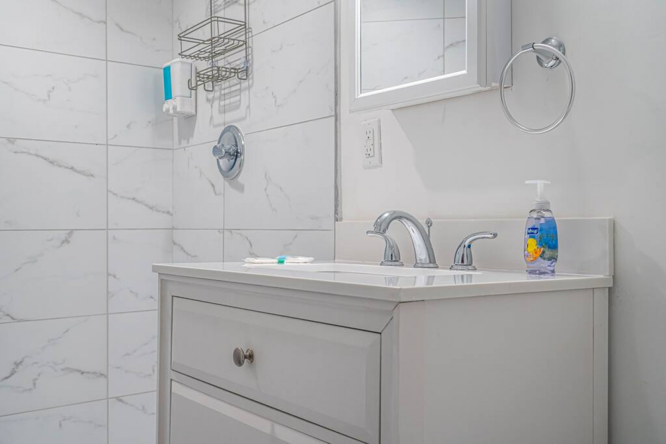 The bathroom is decorated in a minimalist style, with simple and clean-lined fixtures. The white toilet, sink, and bathtub are all in good condition and appear to be well-maintained. The walls and floors are also clean and free of any damage.