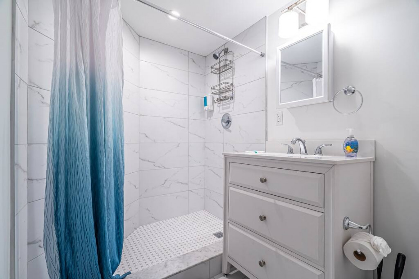 The bathroom is decorated in a minimalist style, with simple and clean-lined fixtures. The white toilet, sink, and bathtub are all in good condition and appear to be well-maintained. The walls and floors are also clean and free of any damage.