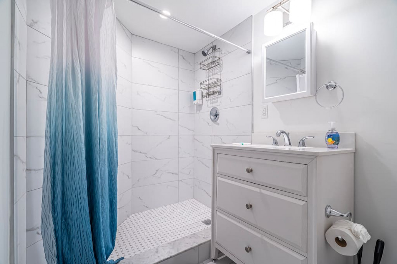The bathroom is decorated in a minimalist style, with simple and clean-lined fixtures. The white toilet, sink, and bathtub are all in good condition and appear to be well-maintained. The walls and floors are also clean and free of any damage.