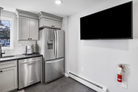 TV on kitchen wall allows Bar seating for the big game