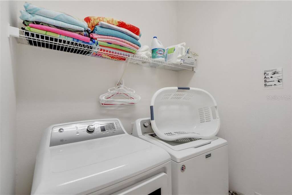 Leading off from the foyer, the utility area features a very large washer and dryer as well as an iron and ironing board Leading off from the foyer, the utility area features a very large washer and dryer as well as an iron and ironing board - PREMIUM 5 Bed, 4 Bath Villa w/Pool, Near Disney - Davenport