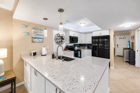Bright coastal kitchen with spacious granite island and modern finishes