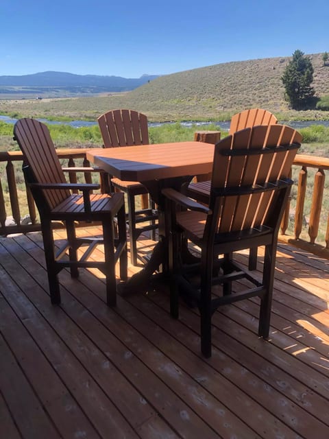 Lot of outdoor dining seating, multiple tables and chairs and a large picnic table. *This set is new.