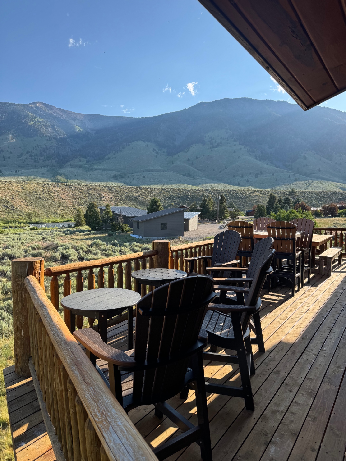 Looking to mountains on the deck, lots of seating and newer Weber gas grill around corner. 