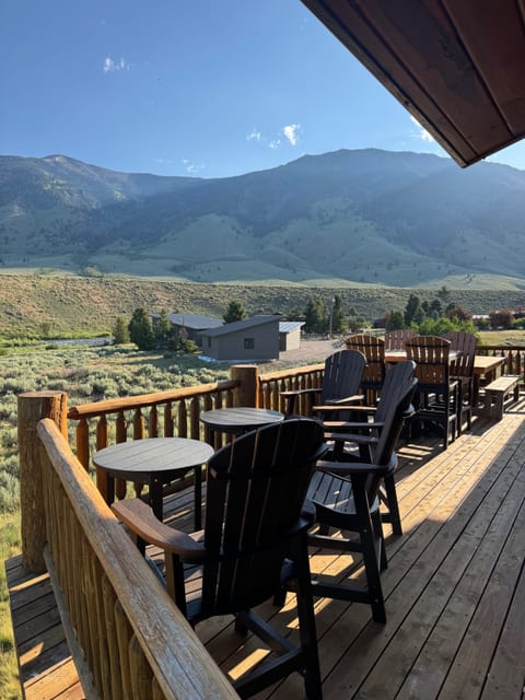 Looking to mountains on the deck, lots of seating and newer Weber gas grill around corner. 