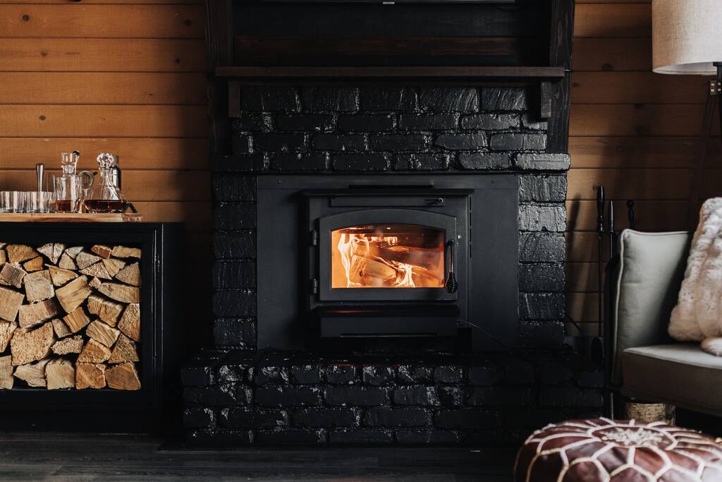 The whiskey bar is sitting on top of a box of wood which is next to the fireplace. This wood is SOLELY decoration and not to be used for firewood. Please bring your own firewood for our indoor wood burning fireplace.
