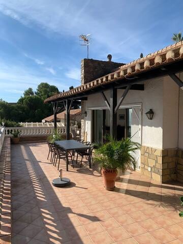 Outdoor dining table at the exit from the lounge. The upper terrace
