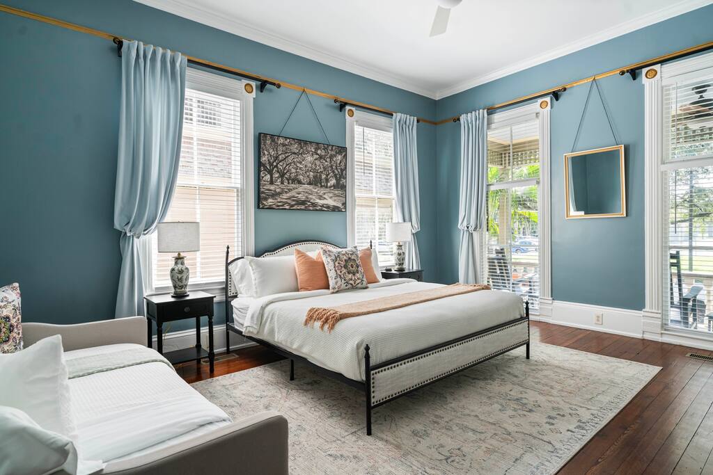 Large 1st floor bedroom featuring a remarkably comfortable bed, twin day bed, antique armoire and sitting area.  Huge floor to ceiling windows bring in lots of light and that touch of southern charm!