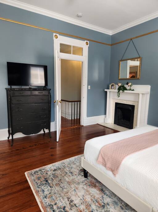 Enjoy the beautiful antique dresser.  The original fireplace (non-working) adds additional charm to this comfy bedroom. 