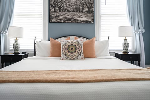 Bright, elegant bedroom with plush bedding and charming designer touches