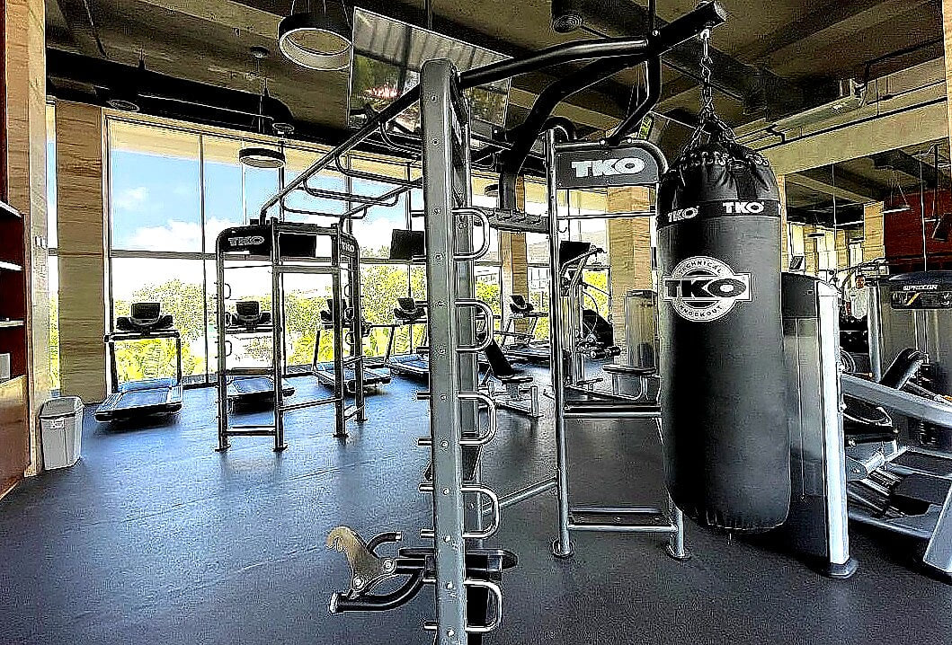 Fully equipped on-site gym at AWA Playacar with free weights, punching bag, and functional training stations for guests staying in our luxury Playacar vacation rentals