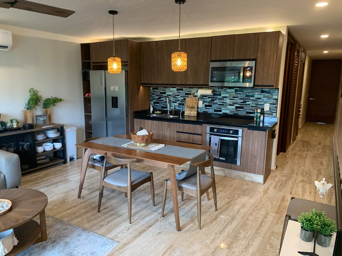 A sleek, modern kitchen outfitted with high-end appliances, premium cookware, and everything needed for effortless gourmet cooking during your stay.