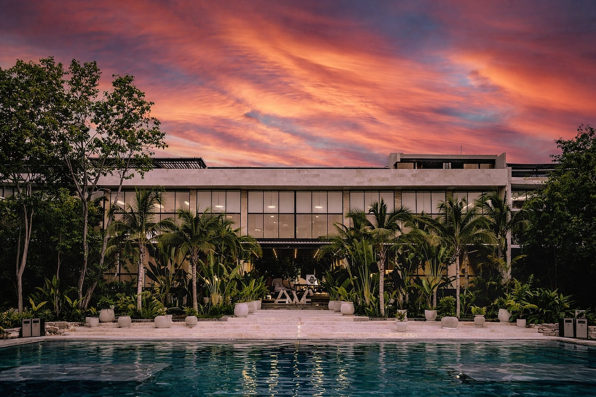 Stunning sunset over the AWA Playacar pool, creating a tranquil luxury resort atmosphere in Playa del Carmen
