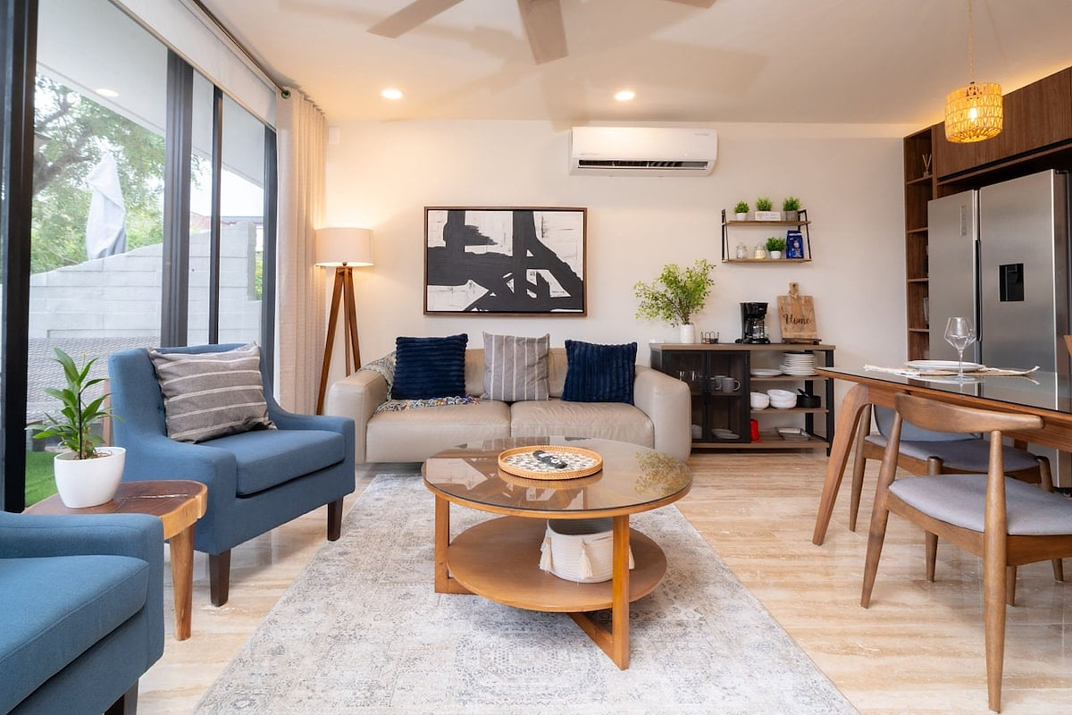 Sun-Filled Modern Living Room With Floor-to-Ceiling Windows

A bright, sophisticated living space bathed in natural light, featuring floor-to-ceiling windows and refined contemporary décor for a luxurious, welcoming atmosphere.
