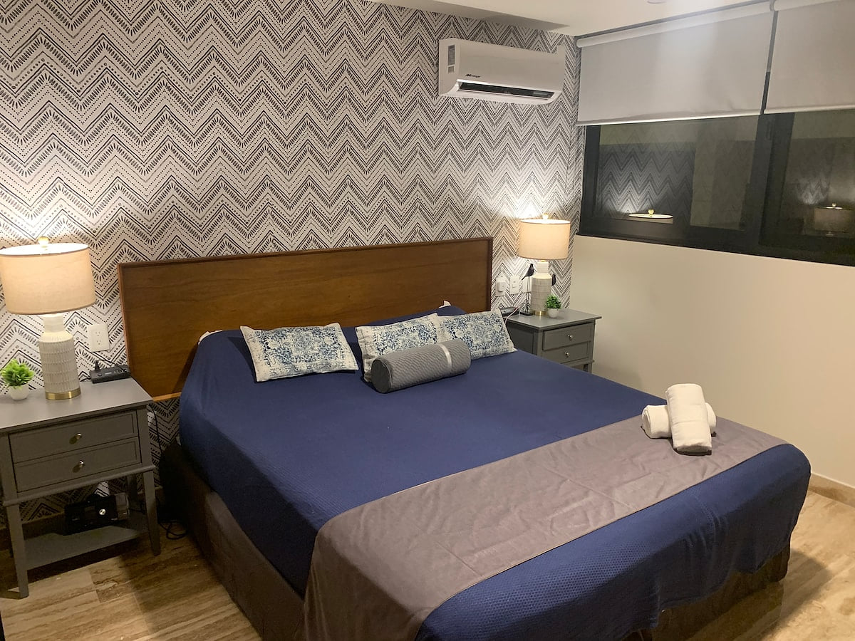 Stylish Bedroom with Modern Comforts Rest easy in a beautifully designed room featuring a plush bed, chic decor, soft lighting, and calming tones.