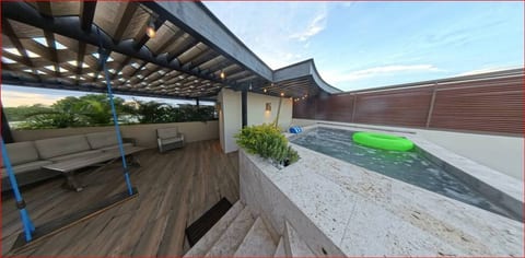 Create unforgettable memories with friends and family on this stunning rooftop terrace, featuring a plunge pool, dining area, and lounge seating.