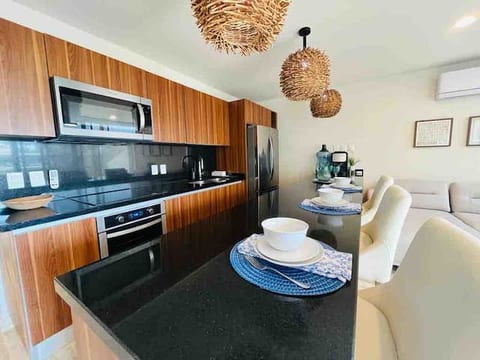 Whip up delicious meals in this modern and functional kitchen, featuring sleek stainless steel appliances and plenty of counter space.