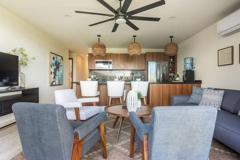 Relax and unwind in this stylish and spacious living area, featuring comfortable seating, a modern kitchen, and stunning views.