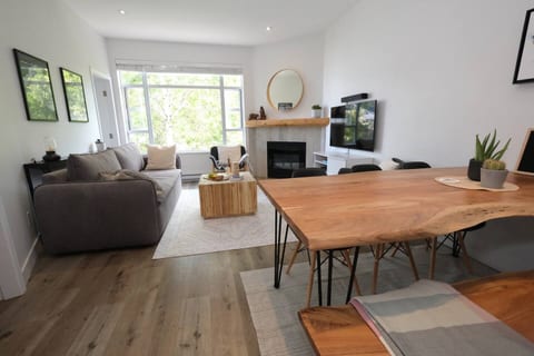 Dining Area - Beautiful live edge table seats 6. One side has a bench for 3 people. The other side has 3 separate seats for 3 people.Note: Wine & food is staged for illustration purposes
