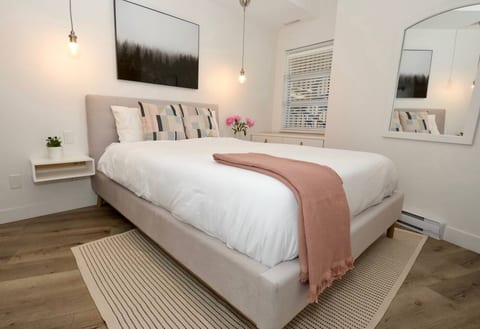 Master Bedroom - The bed is surrounded by a rug to rest your feet as you wake. The bed is has built in bedside tables & 2 pendant lights to create the right amount of lightingNote: Flowers were staged for illustration purposes (not included)