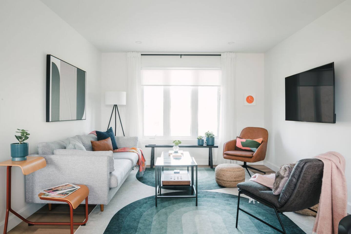 Living room - Ready for movie night. This space equipped with a 55" smart TV and a myriad of throw pillows and blankets to get cozy.