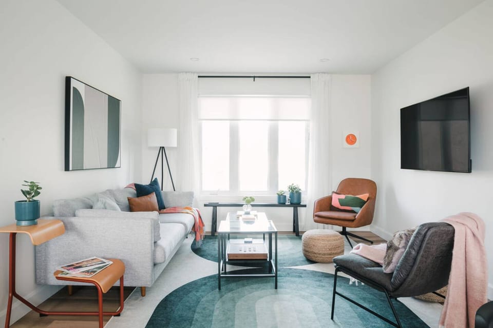 Living room - Ready for movie night. This space equipped with a 55" smart TV and a myriad of throw pillows and blankets to get cozy.