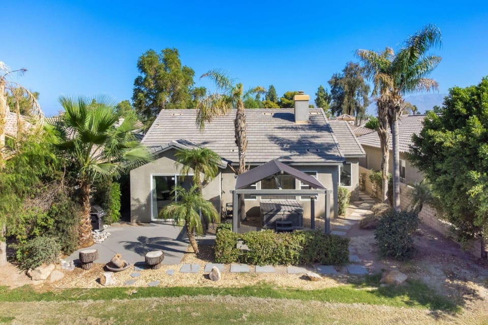 Outdoor Retreat: Relax in the sun surrounded by palm trees and lush landscaping! Perfect for gatherings.