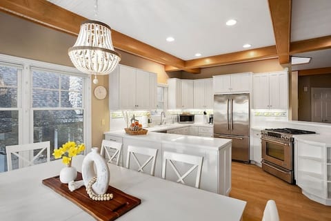 Bright and spacious kitchen is located on the second floor. Offers Jenn Air and Samsung appliances as well as a drip and Keurig coffee maker. Enjoy family and friends at the table while still enjoying lake view.