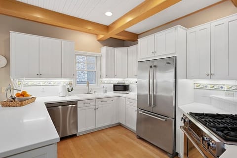 Bright and well stocked kitchen provides pots, pans, coffee makers, serving dishes, utensils, toaster, microwave, baking dishes, food storage, and more for memorable friends and family mealtimes.