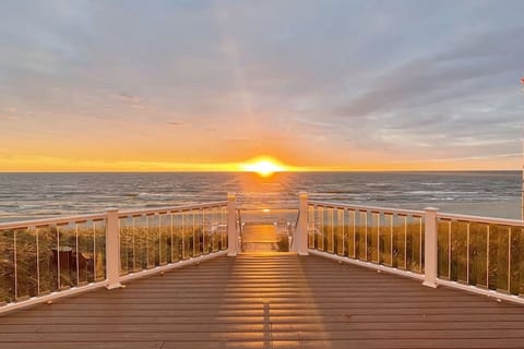 Large deck off the main level sunroom is a great place to enjoy beach, sunset, and lake views at all times of the day.