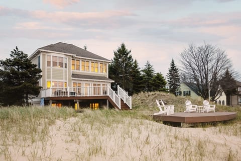 View of the house, main level deck and extended deck from the beach.