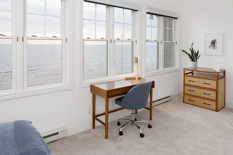 Enjoy amazing Lake Michigan and sunset views from the workspace located on the top floor inside the queen bedroom