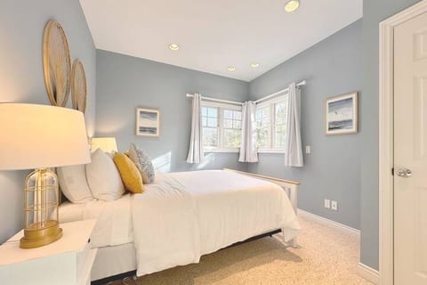 Queen bed bedroom located just past the main level living room has access to the main level full bath just around the corner. An entry and exit to the home is also available through sliding glass doors. All windows have blackout curtains