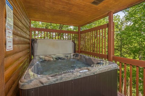 Enjoy the seclusion of this 5-person hot tub and the surrounding beauty of the peaceful wooded area.