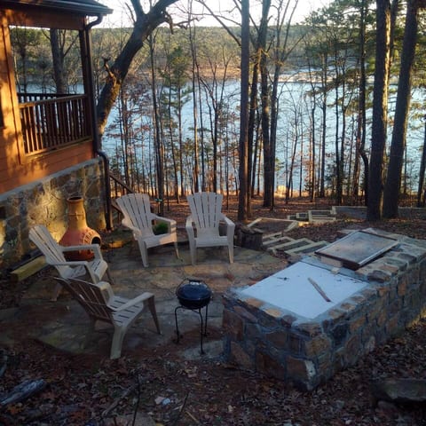 Outdoor seating area with a fire pit and BBQ grill, ideal for cozy evenings and marshmallow roasting under the stars